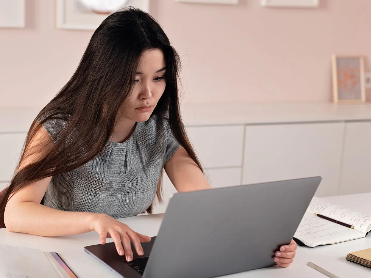 Operations professional working from a laptop in a modern office